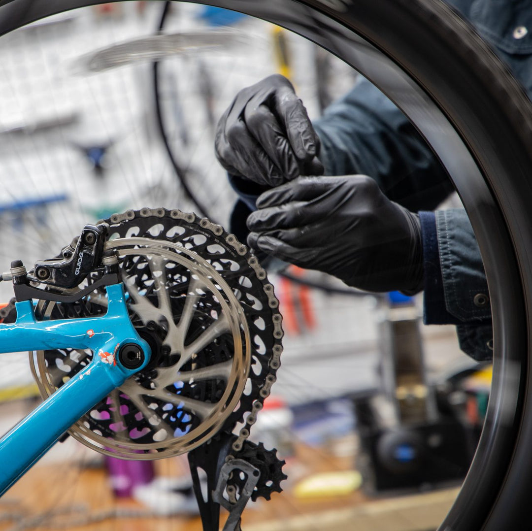 Someone tuning a bike in Park City at Switchback Sports